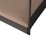 Raised pet bed with dark wicker frame and beige cushion at the corner