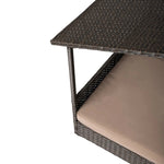 Raised pet bed with dark brown wicker frame and beige cushion, side view