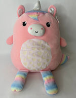 Large pink plush animal with rainbow legs, unicorn horn, and heart-pattern belly