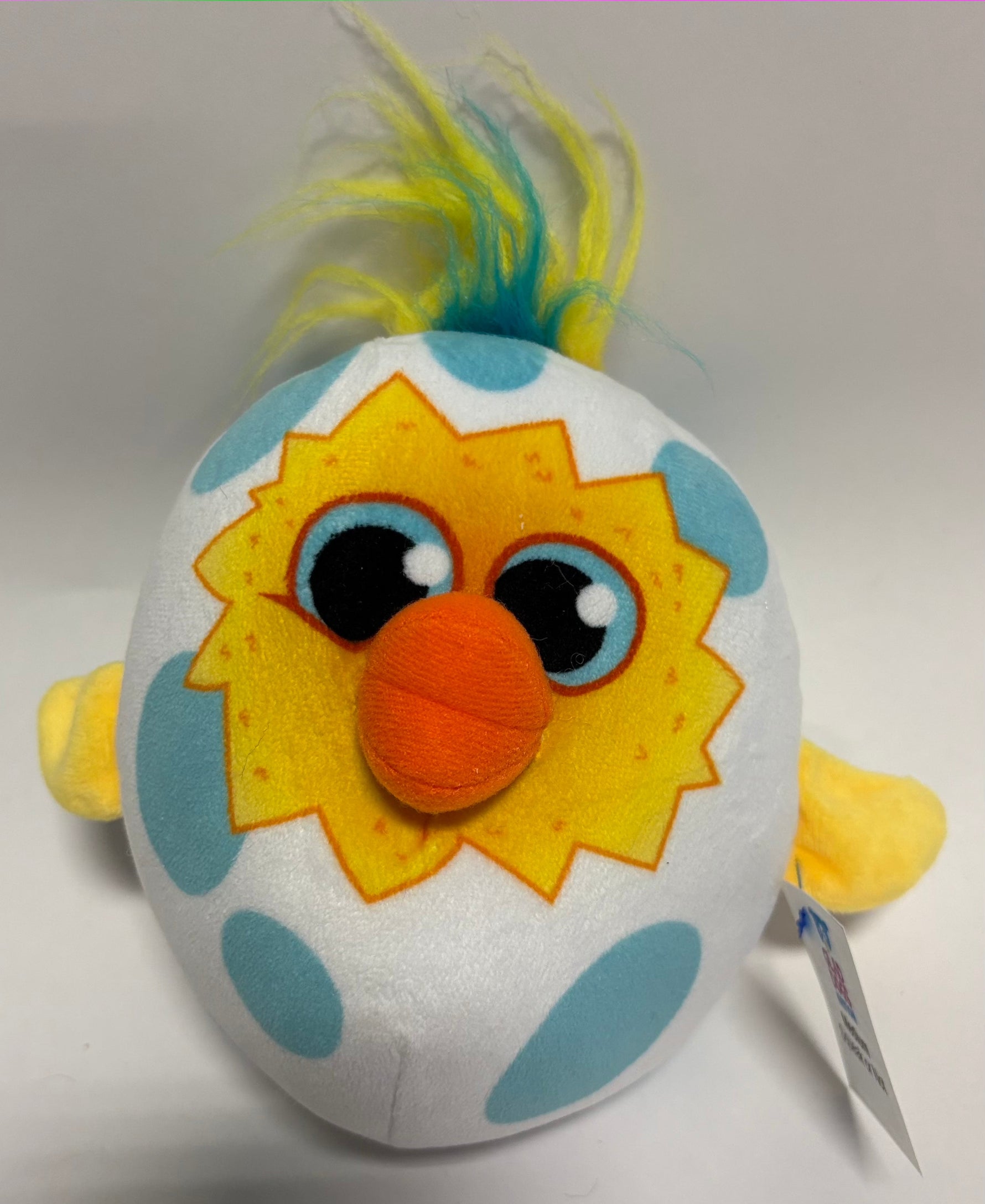 White plush dog toy with blue patches and lion face graphic