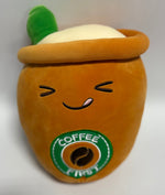 Large orange plush drink character with smile face and green “Coffee” badge
