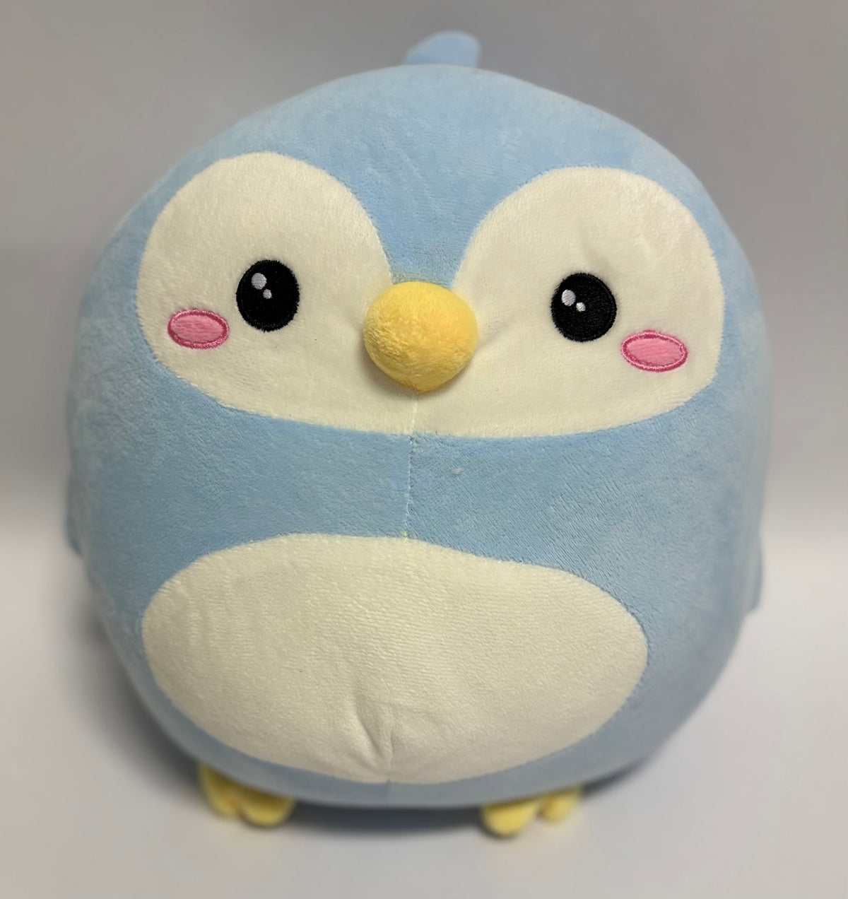 Large light blue plush owl with big eyes, pink cheeks, and cream belly