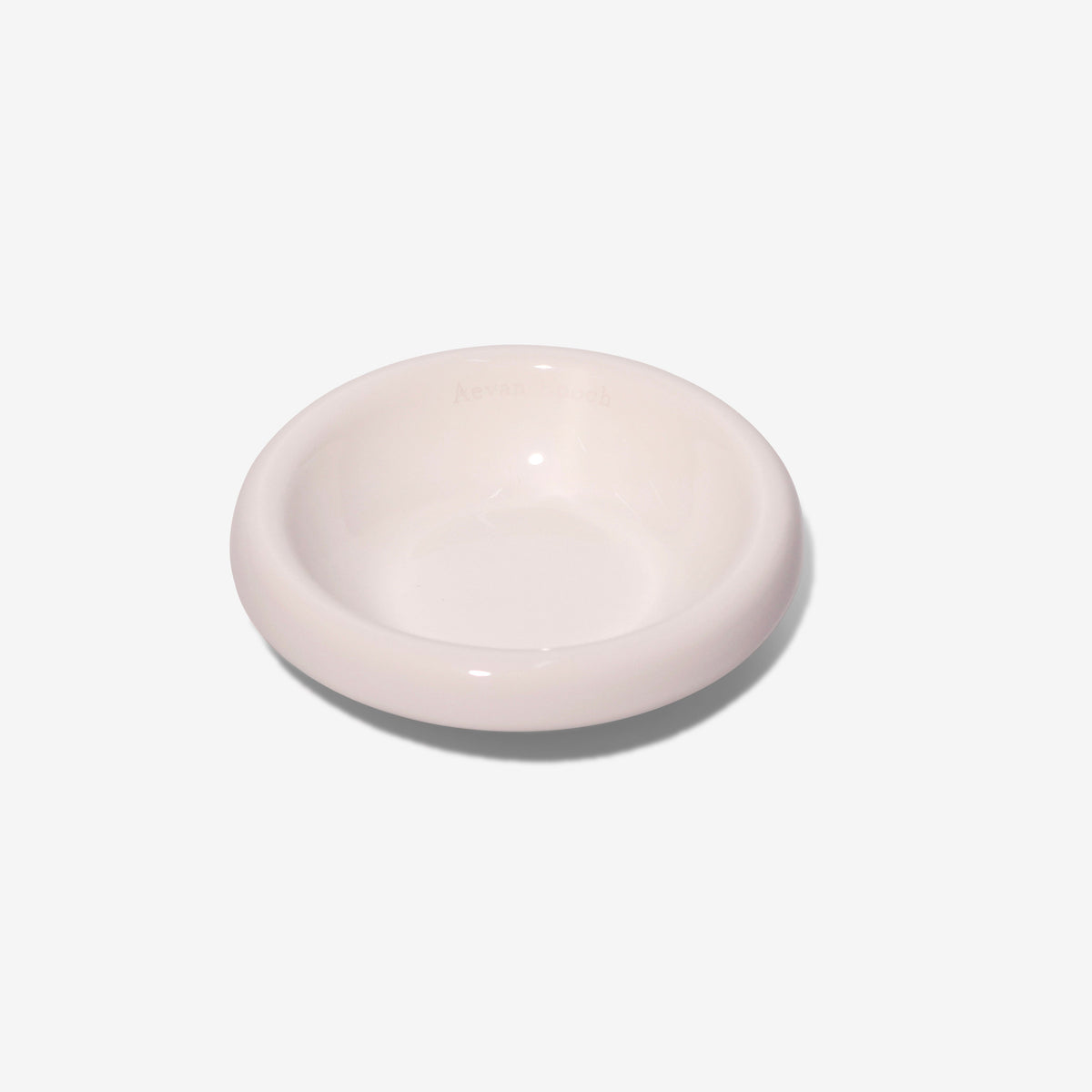 Stoneware pet bowl, glossy pale pink, shallow round dish with raised rim