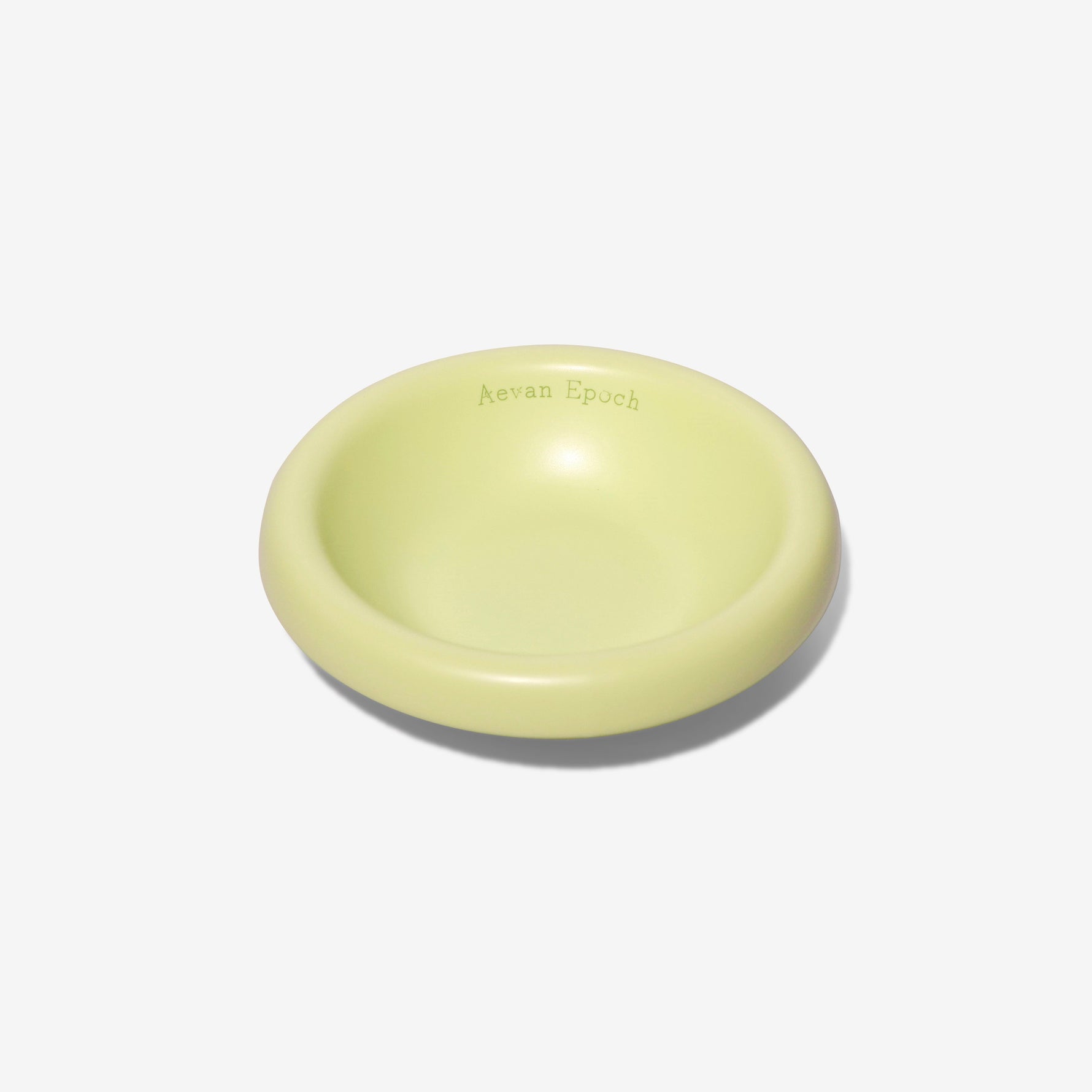 Stoneware pet bowl, glossy pale yellow-green, shallow round dish with raised rim
