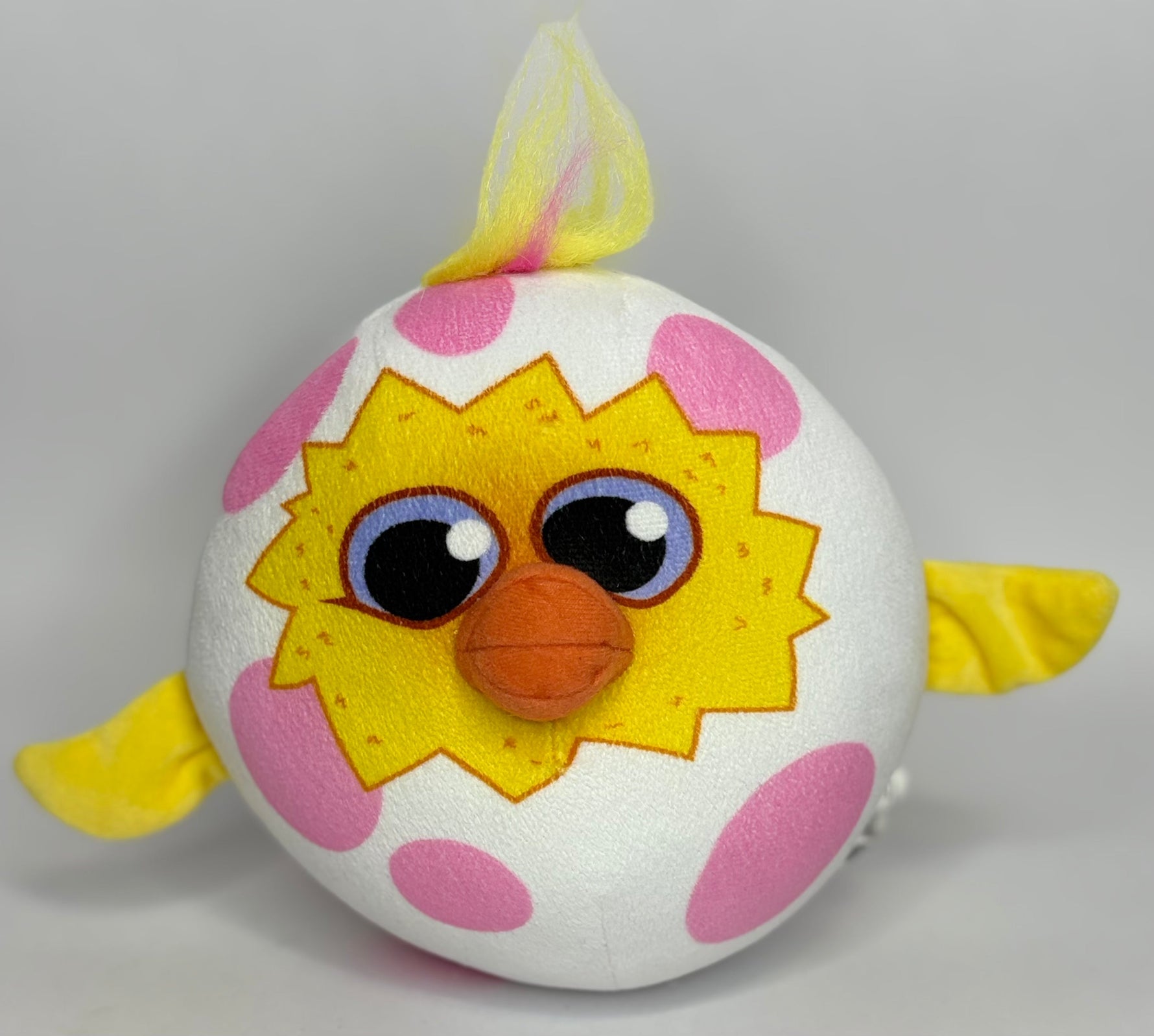 White-and-pink plush round dog toy with star face and colorful tuft