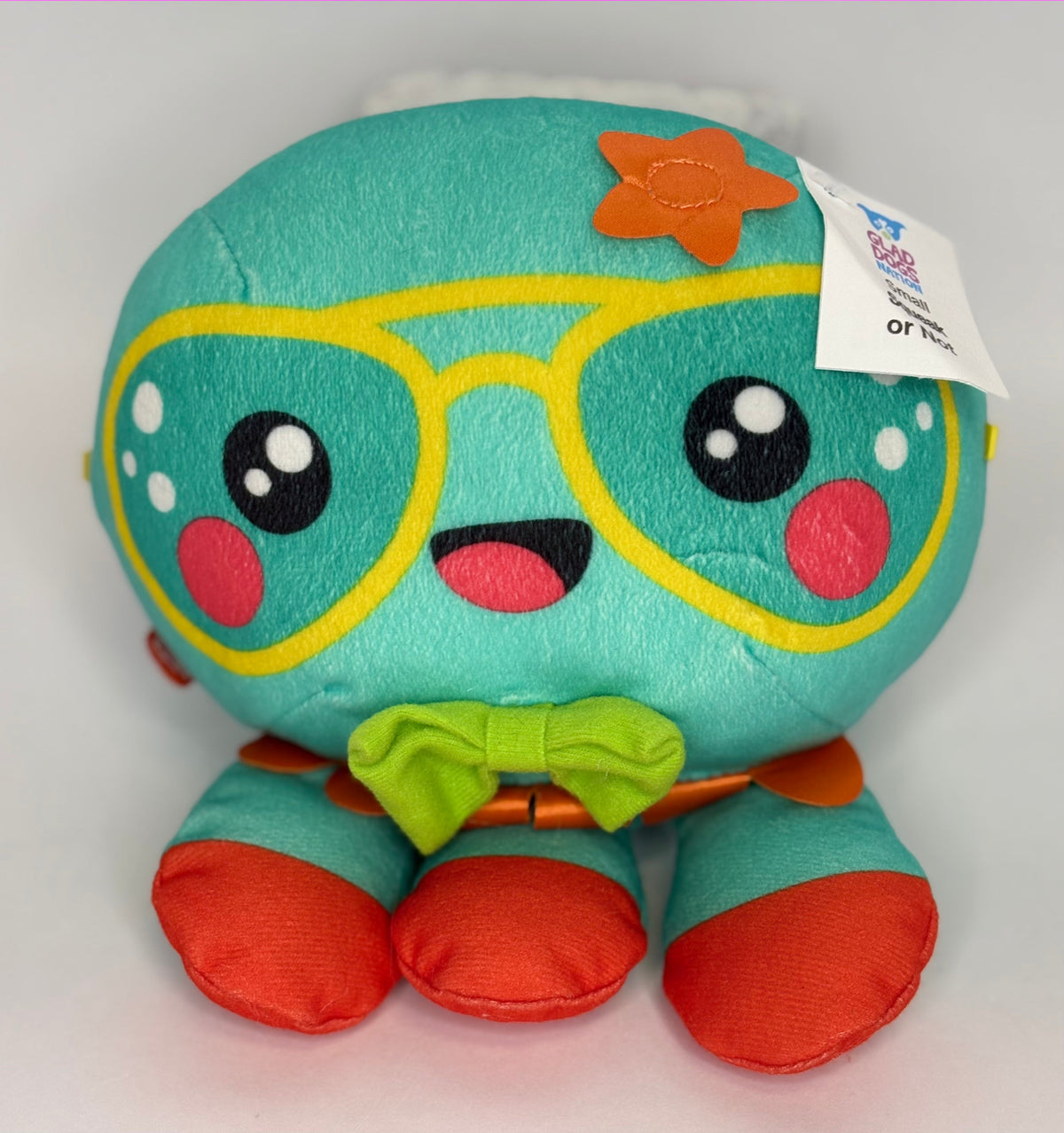 Teal plush dog toy with glasses-style face and red paw accents