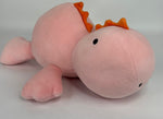 Large pink plush narwhal-like character with orange fins and small black eye