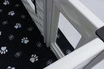 Window side panel with white frame over black paw-print mat