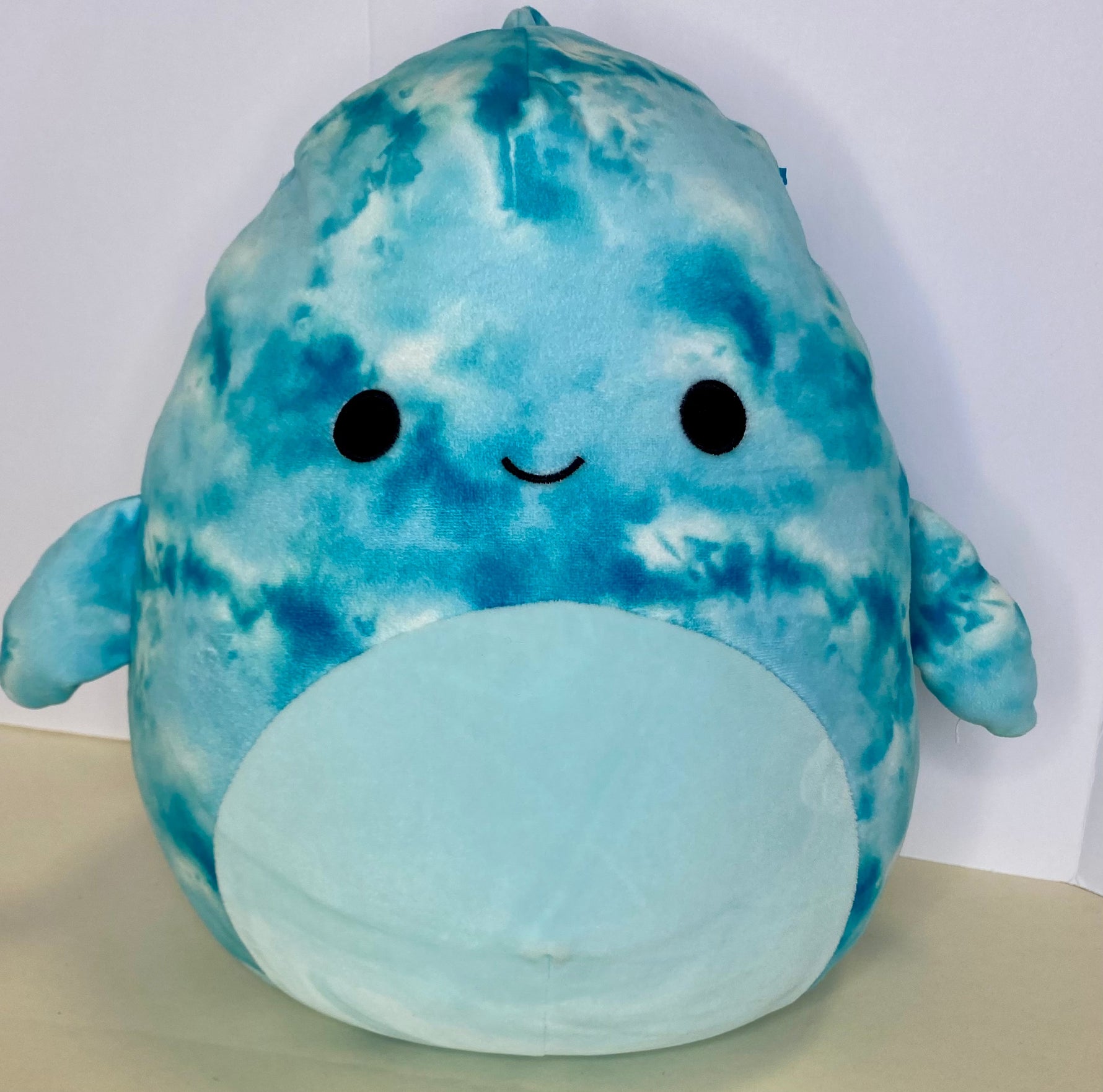 Large blue tie-dye squishy dolphin plush with cute face and cream belly