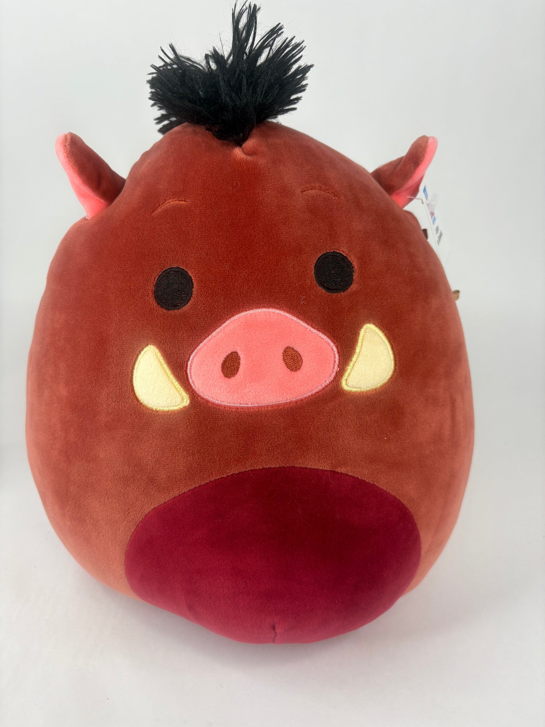 Large squishy pig plush, red with black eyes, pink snout, and small top tuft
