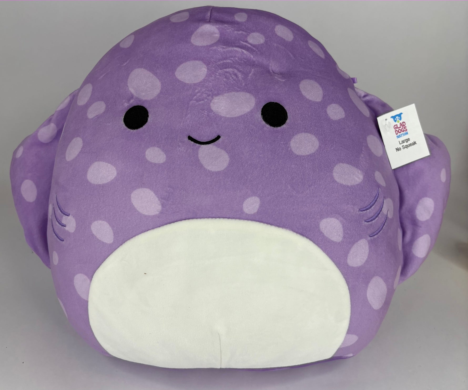 Large squishy plush pet toy, purple whale with white polka dots and smiling face