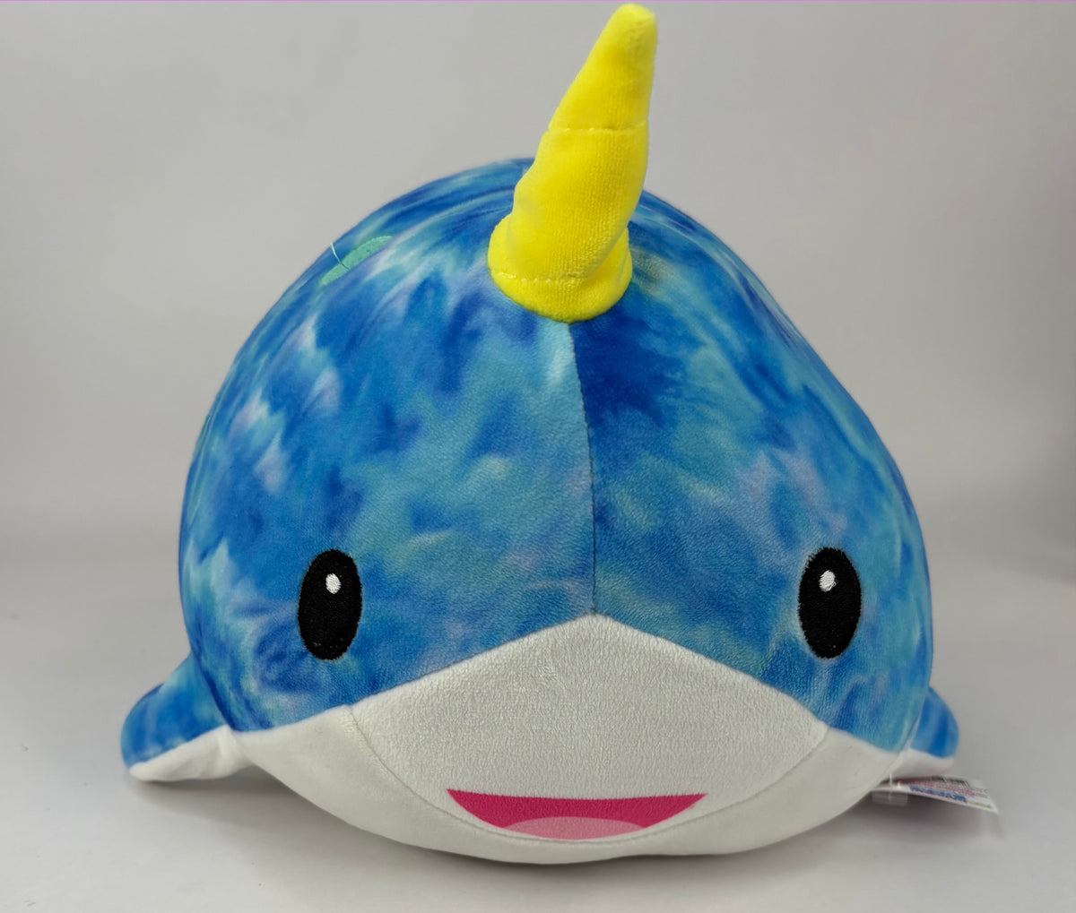 Large squishy plush pet toy, blue and green whale with yellow horn and smiling mouth