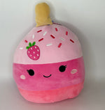 Large pink strawberry plush pet toy with smiling face and squishy body