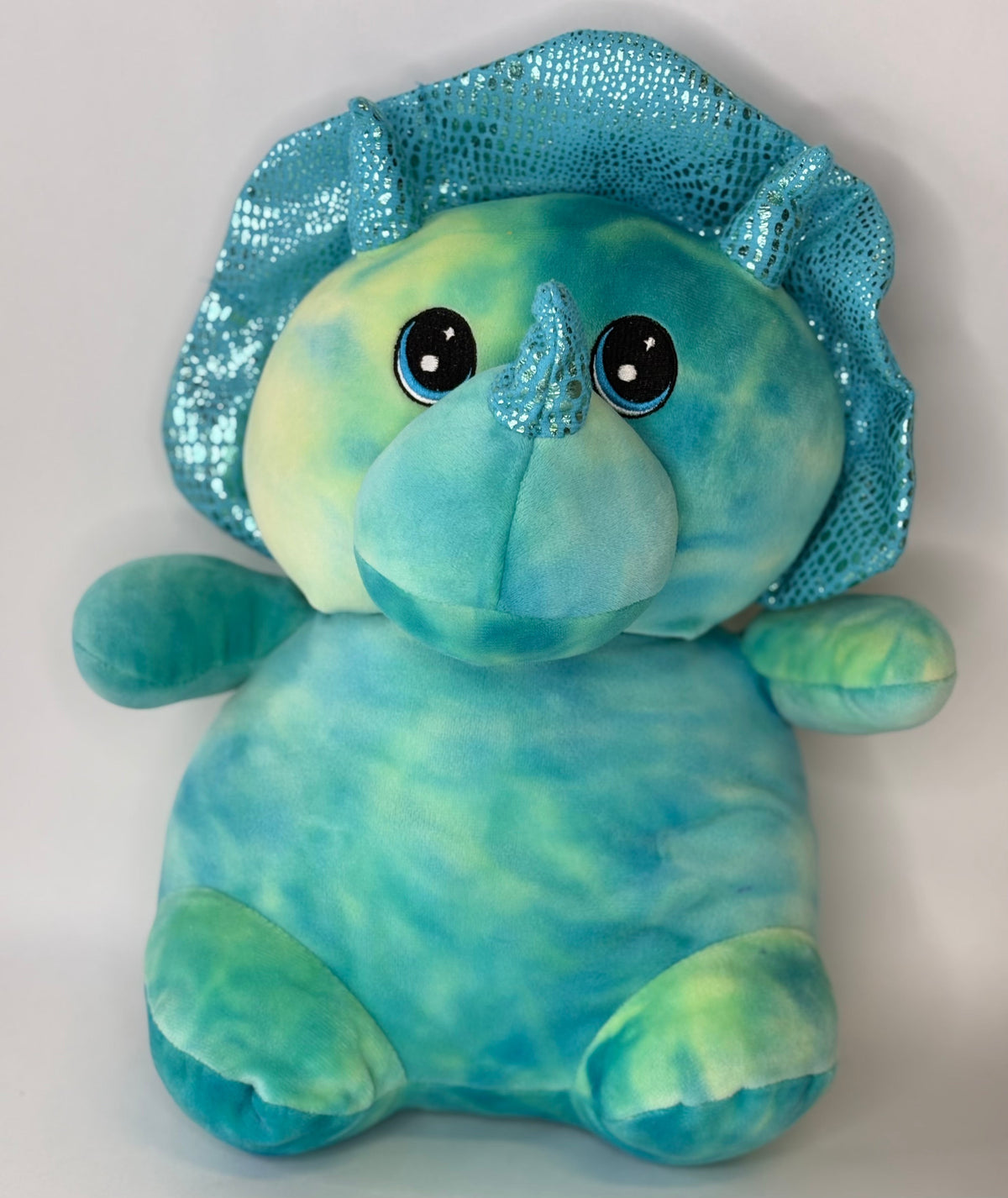 Large blue and teal plush pet toy with big eyes, webbed tail, and squishy body
