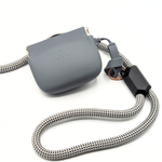 Gray silicone treat pouch with braided strap and metal clip, side view.