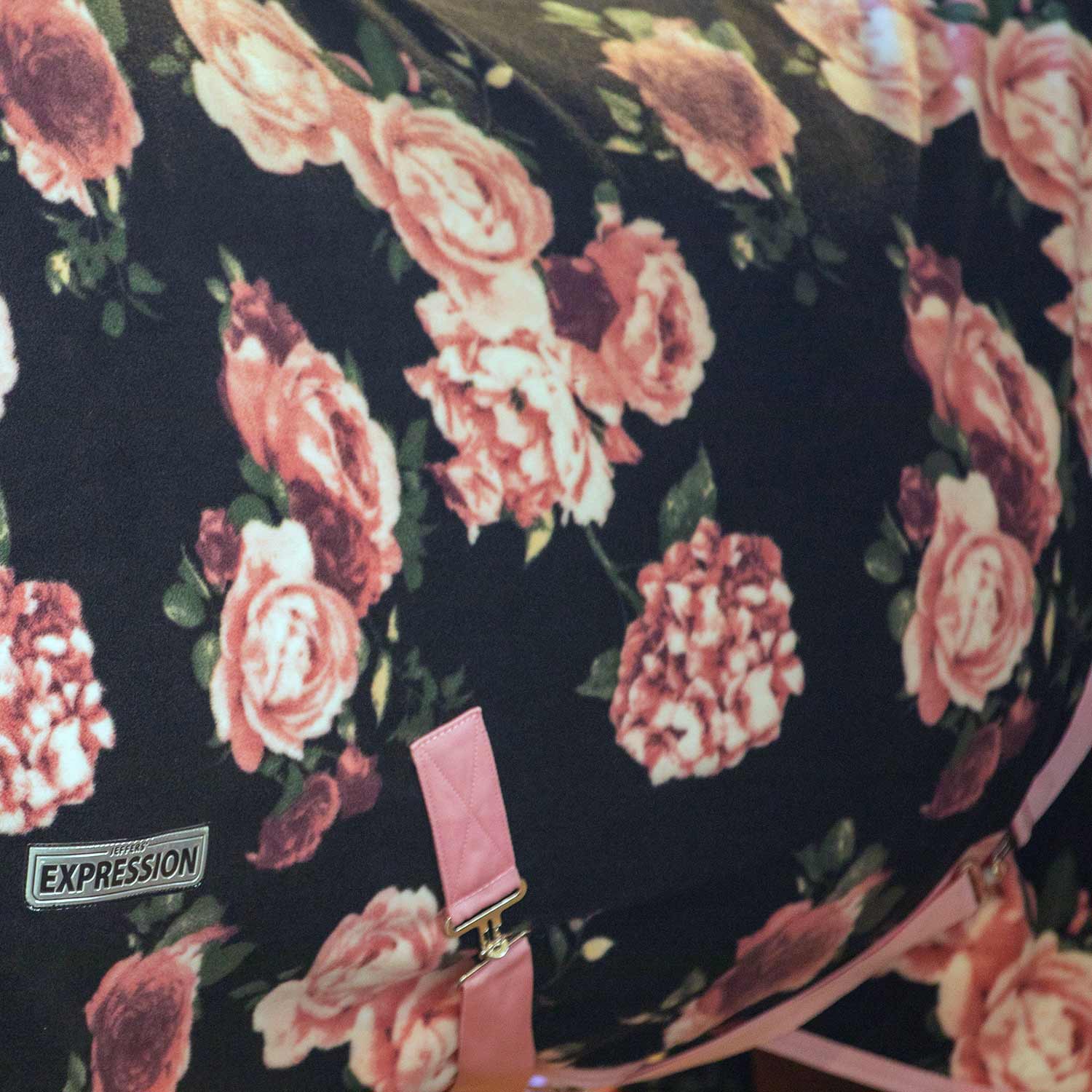 Black fleece fabric with pink rose floral pattern