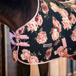 Black floral fleece horse cooler with pink straps and front buckles