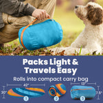 Rolled blue foldable dog bed in compact carry bag with straps