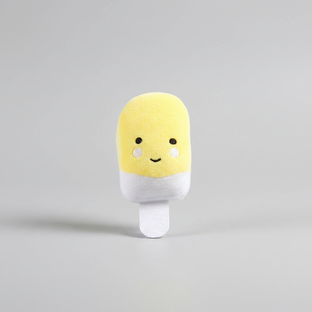 Yellow plush capsule-style dog toy with white legs and cute face
