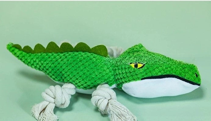 Green crocodile rope dog toy with squeaker, white teeth and belly stitching