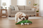 Green crocodile rope dog toy with squeaker on a wooden floor with a dog nearby
