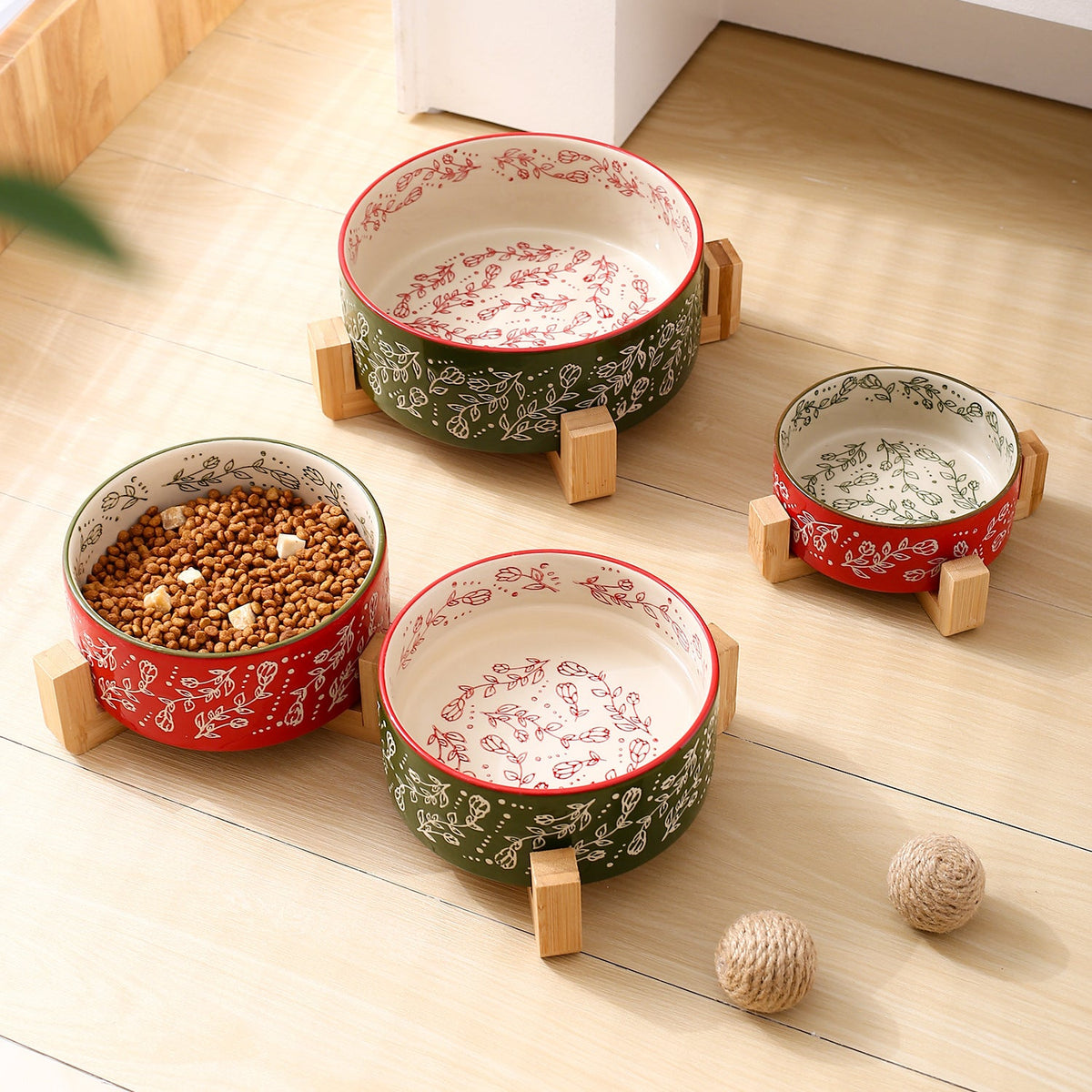 Ceramic pet bowl set with wooden stands, red and green garden-pattern bowls