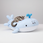 Plush whale-shaped pet bed with blue fins and striped base