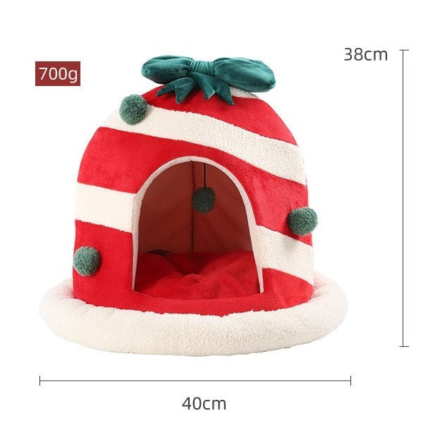 Red and white striped candy hut pet bed with green leaf topper and round open entrance.