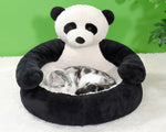 Panda plush pet bed with raised cushion and sleeping kitten inside