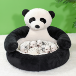 Panda plush pet bed with panda face, black-and-white cushion and bolster, filled with puppies