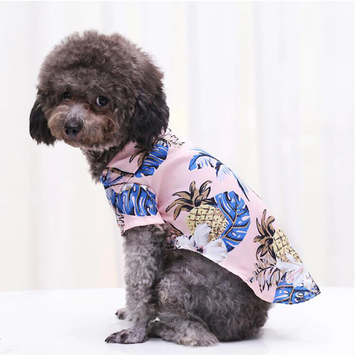 Hawaiian pet shirt in light pink with blue tropical leaf and pineapple print