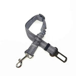 Gray plaid pet car safety belt harness with adjustable clip and metal D-rings.