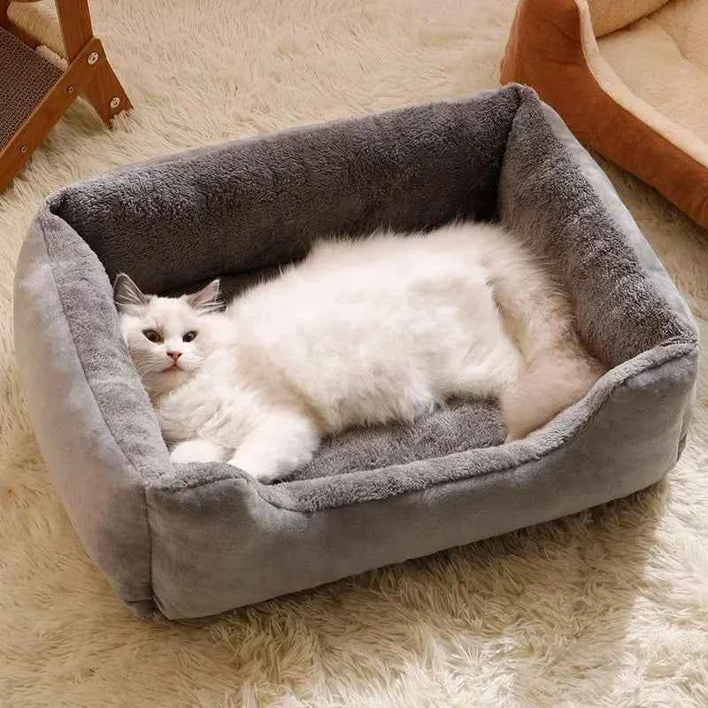 Gray plush pet bed with raised edges and cat resting inside