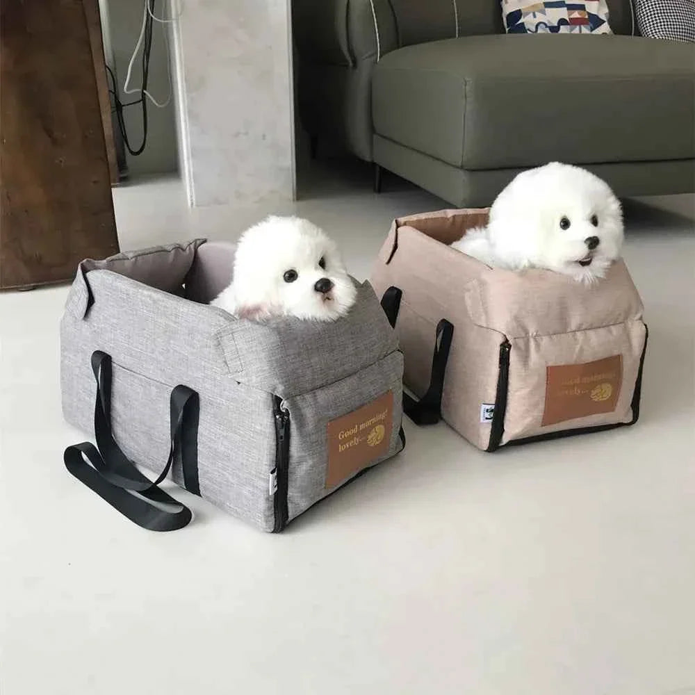 Two small pet car seat beds, gray and khaki, with side handles and raised edges