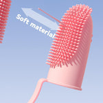 Pink silicone finger toothbrush with soft bristle nubs and flexible finger sleeve for pets.
