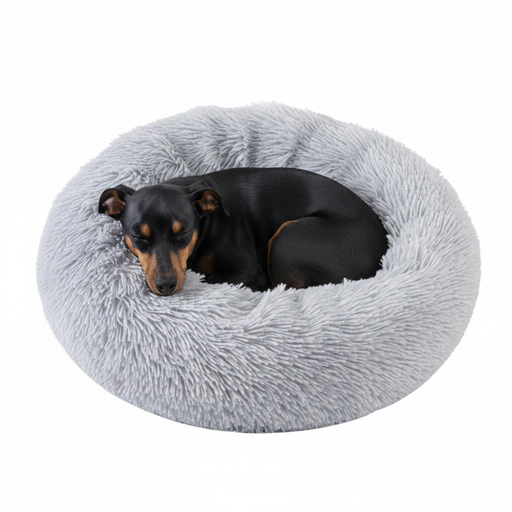 Plush round donut pet bed, light grey shag cushion with sleeping dog