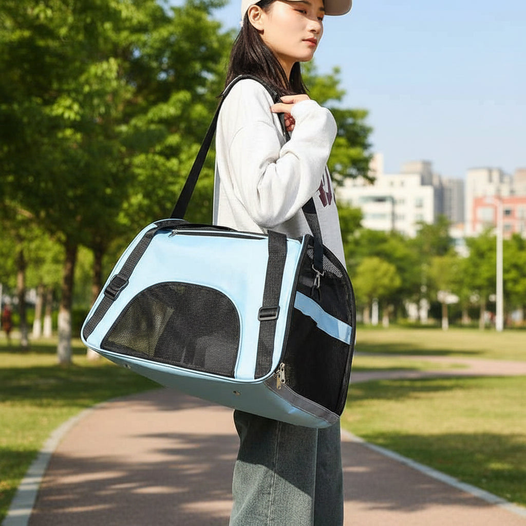 Blue and black pet carrier bag with shoulder strap, mesh sides and zip compartments