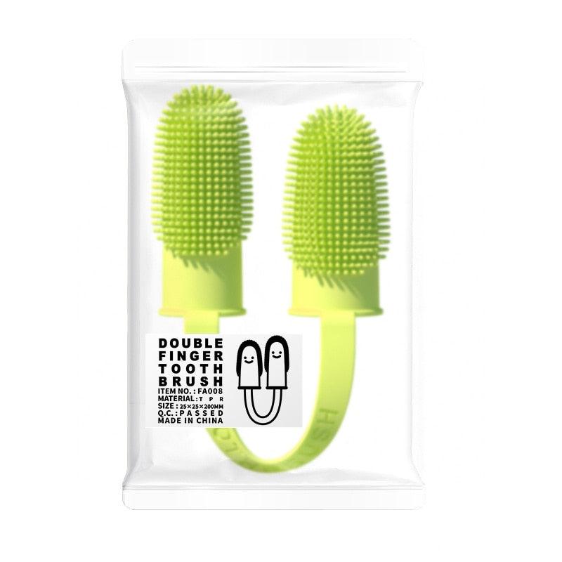 Yellow silicone double finger toothbrush in sealed retail bag