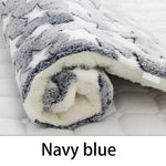 Navy blue flannel pet sleeping mat, close-up of rolled plush edge and dark star pattern