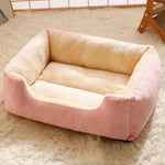 Pink and cream plush pet bed with thick cushioned sides and base
