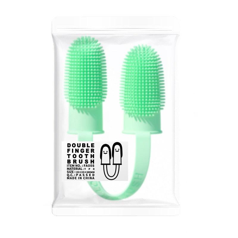 Light green silicone double finger toothbrush in sealed retail bag
