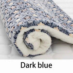 Dark blue flannel pet sleeping mat, close-up of rolled plush edge and textured star pattern