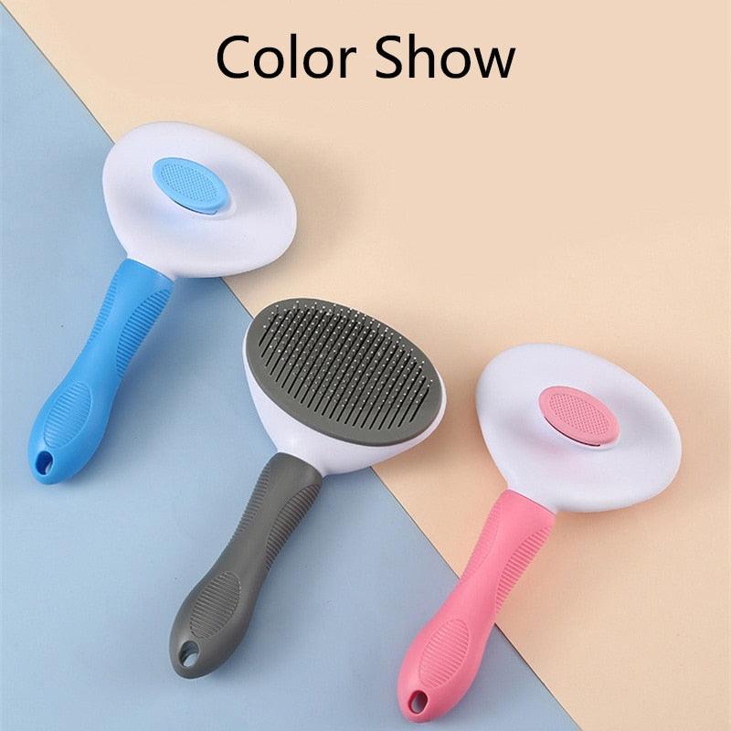 Pet grooming brush with oval stainless pins, blue and pink handles, self-cleaning pad