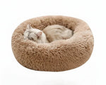 Plush round donut pet bed, tan shag cushion with sleeping cat