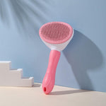 Pink pet grooming brush with oval stainless-pin head and ergonomic handle