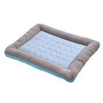 Light blue pet cooling mat with gray striped border and quilted bubble-texture surface