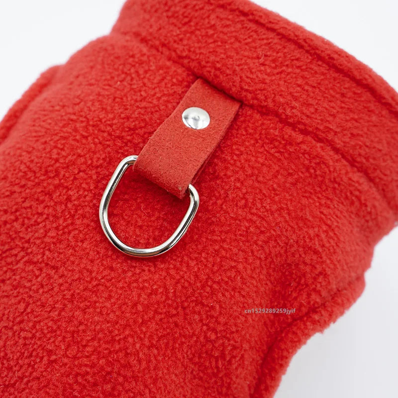 Red fleece dog vest detail with D-ring leash ring and fabric tab