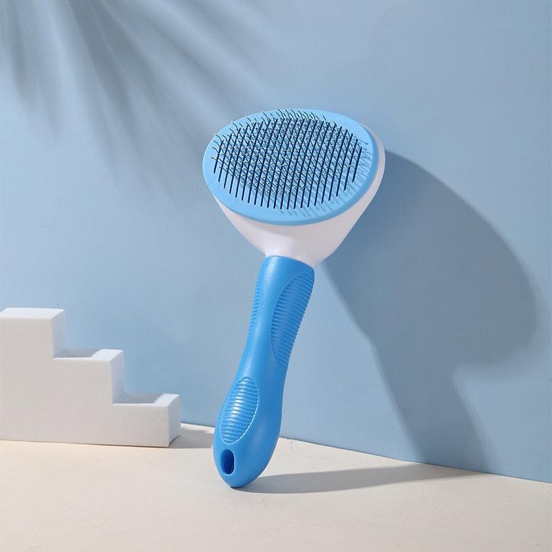 Blue pet grooming brush with oval stainless-pin head and cushioned handle