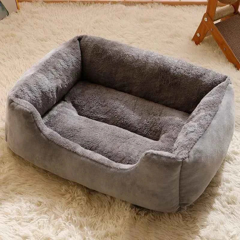 Dark gray plush pet bed with raised edges and cushioned inner floor