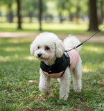Black-and-pink pet jacket with THE DOG FACE patch, worn by small dog with leash clip